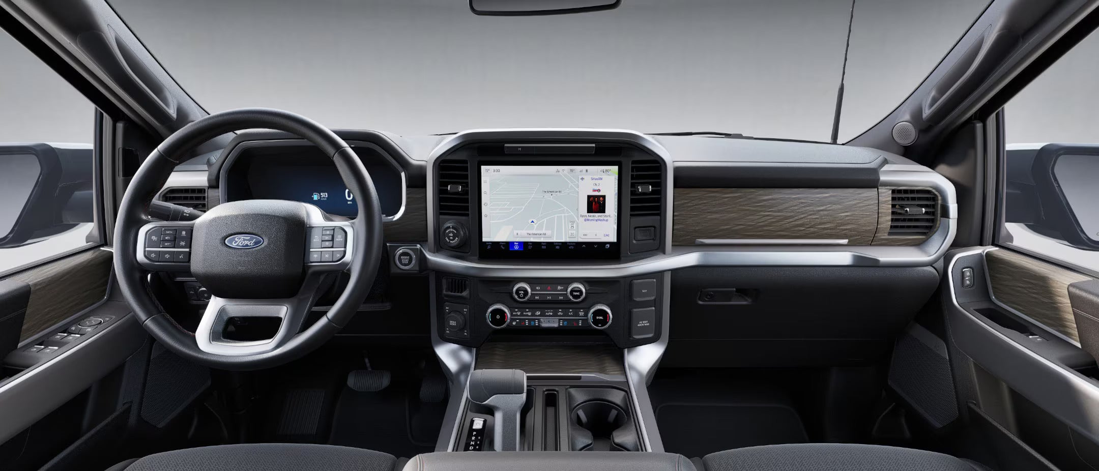 the infotainment and digital cluster display of a 2025 ford f-150 with wood grain accents in the interior