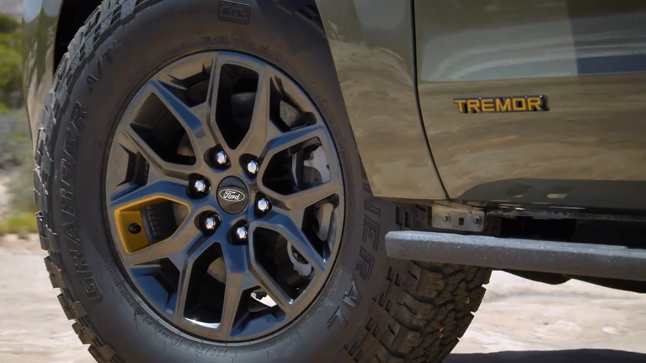 Detailed view of the 2025 Ford Expedition's wheel with Tremor trim badge and rugged tire.
