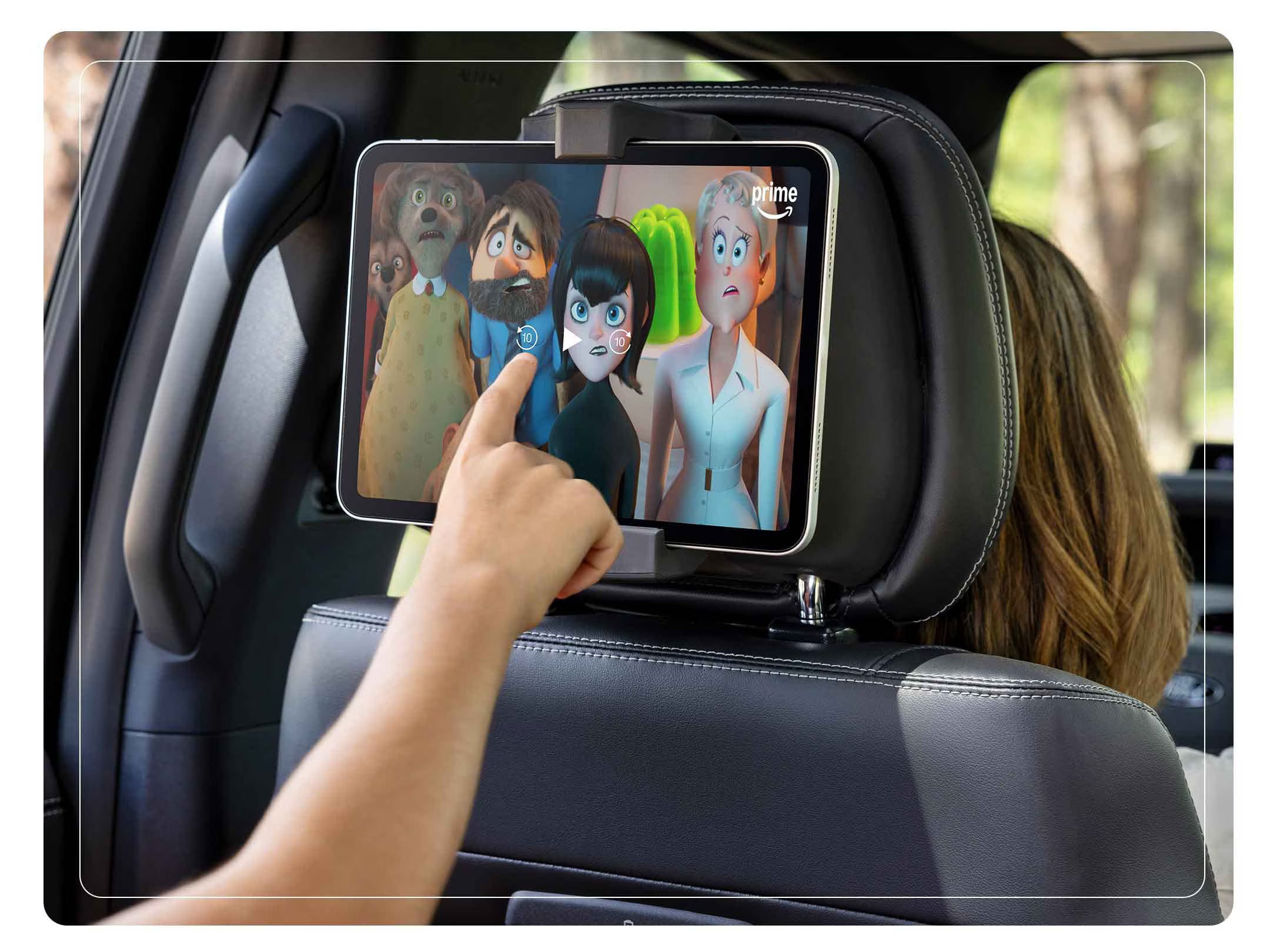 Rear-seat entertainment system in the Ford Expedition playing a cartoon show on a tablet screen.