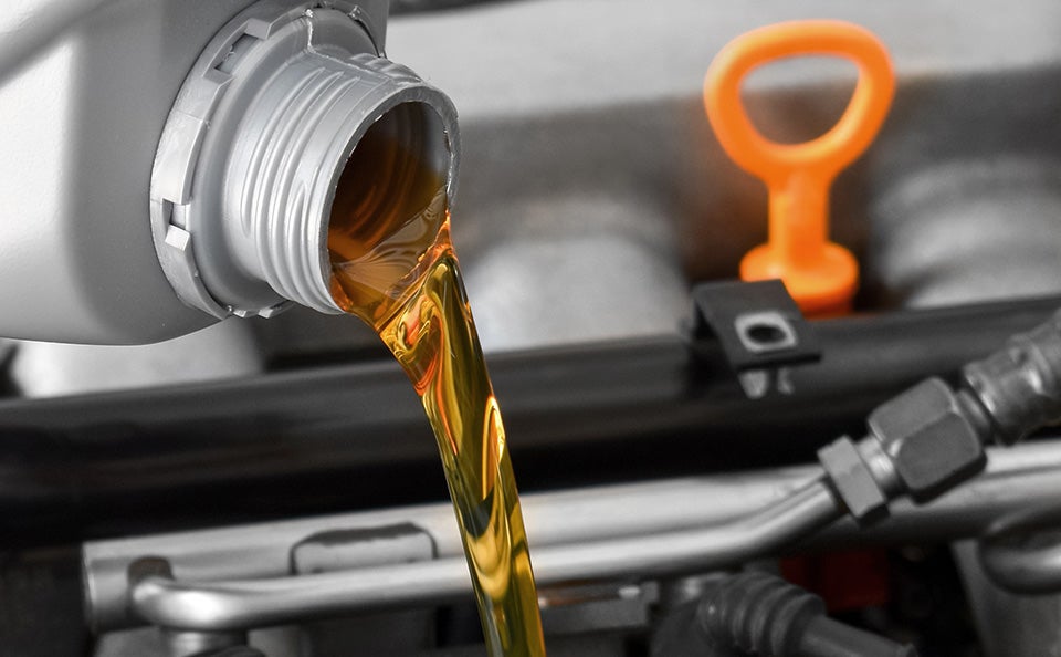 Oil being changed in a car.
